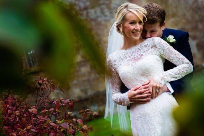Julia Carey being held by James Corden during their wedding.